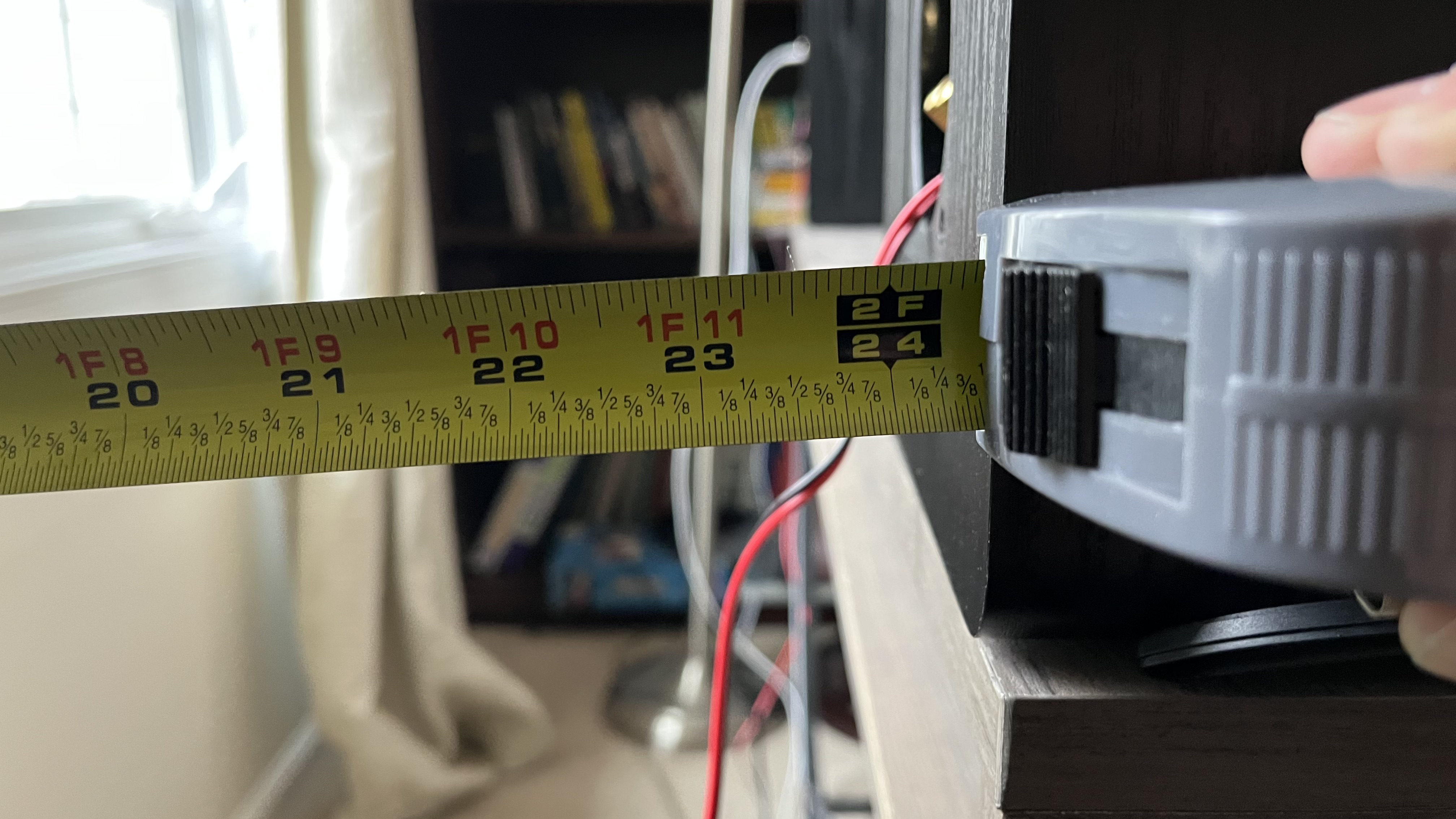 Tape measure showing a Fluance Ai61 stereo speaker to be two feet away from a wall