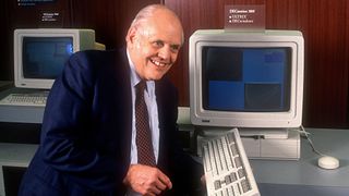 Ken Olsen with a computer and keyboard in 1987
