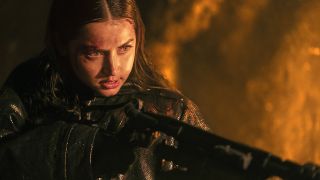 A close up of Ana de Armas' Eve Macarro holding a flamethrower at night in From the World of John Wick: Ballerina