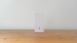 Devolo WiFi 6 Repeater 3000 on a wooden desk