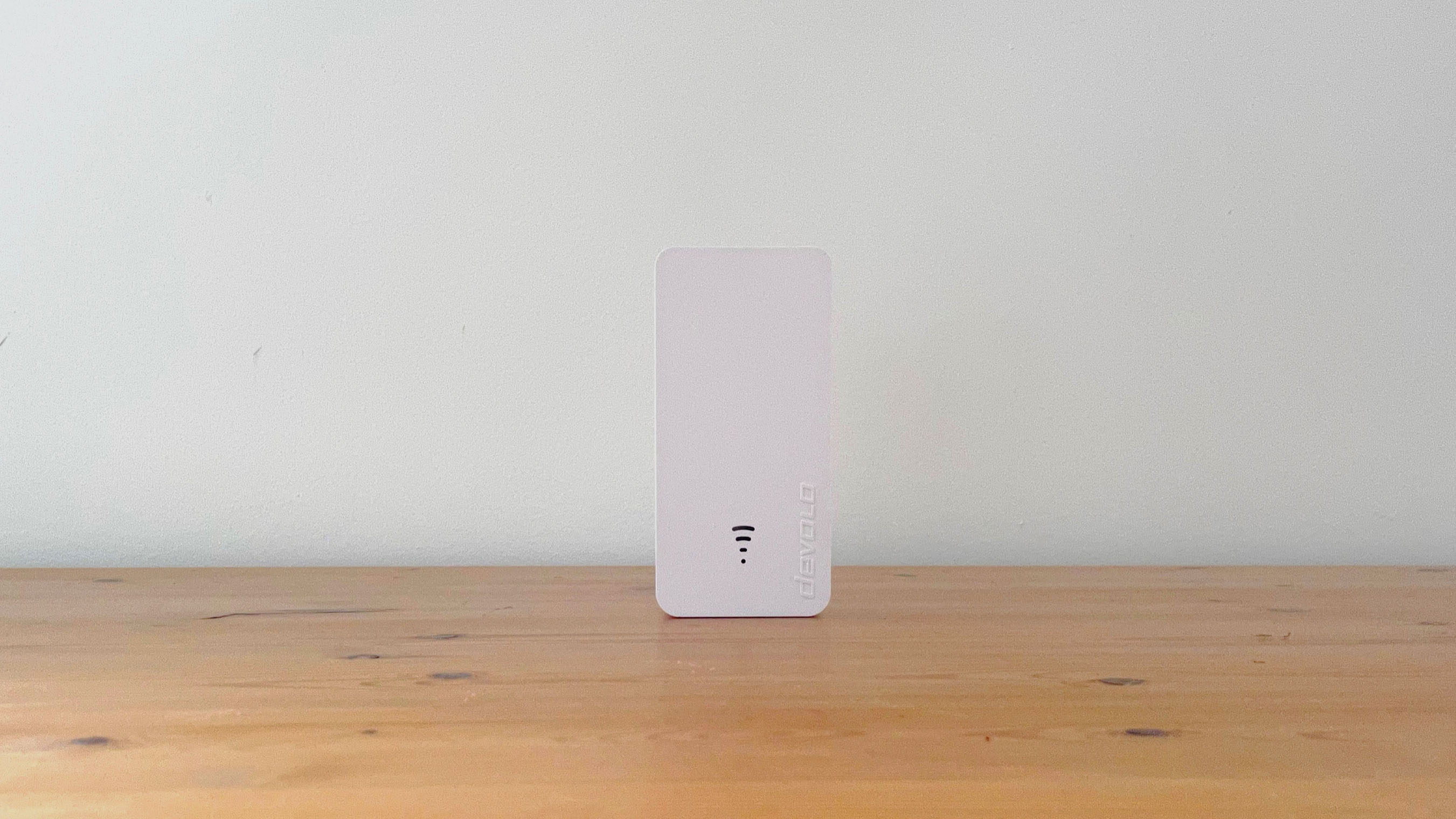 Devolo WiFi 6 Repeater 3000 on a wooden desk