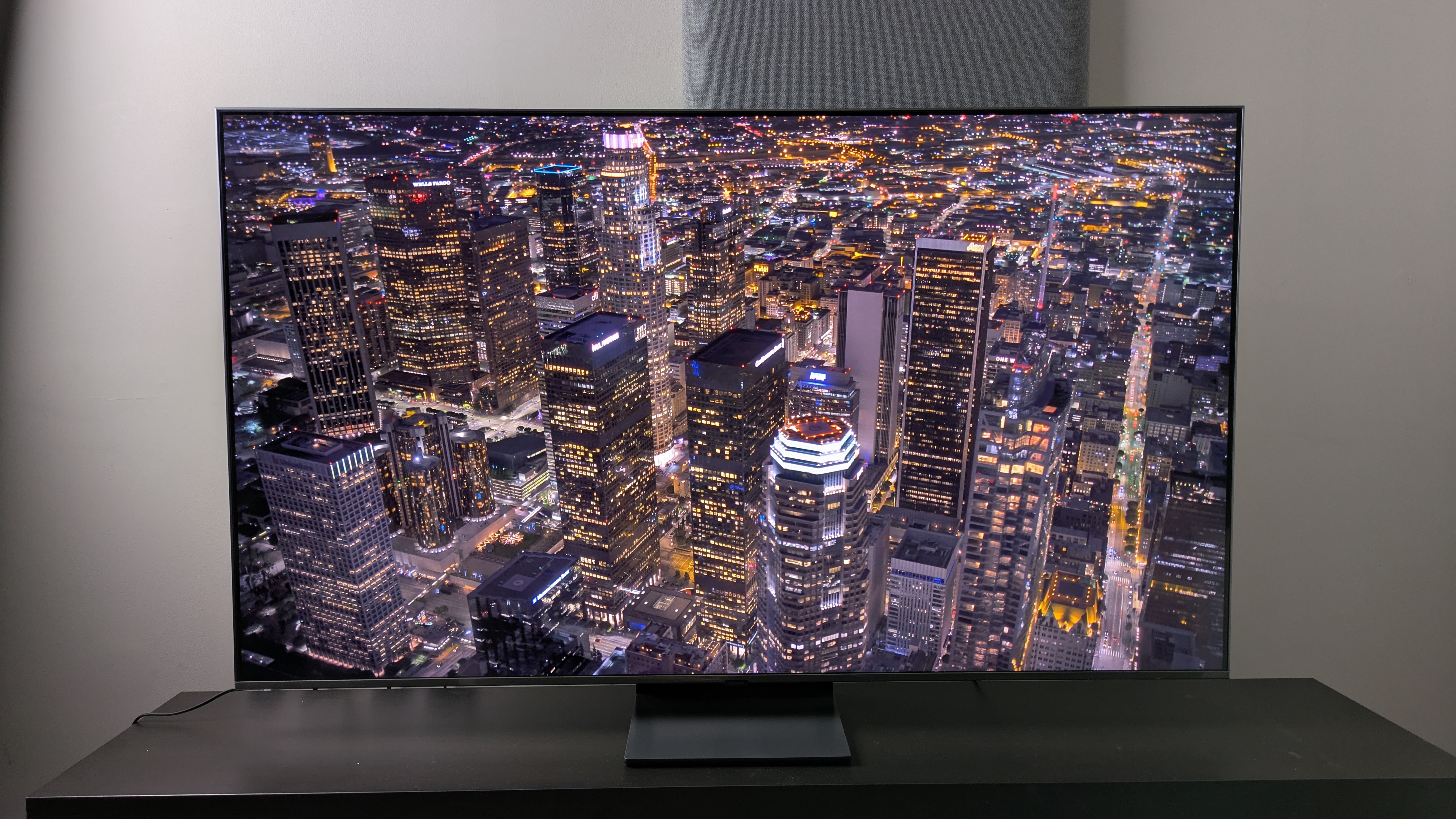 Samsung QN80F with aerial shot of city at night on screen