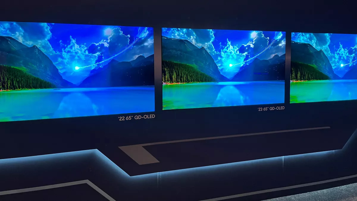 A row of Samsung S95C panels displaying a stylized lake scene.