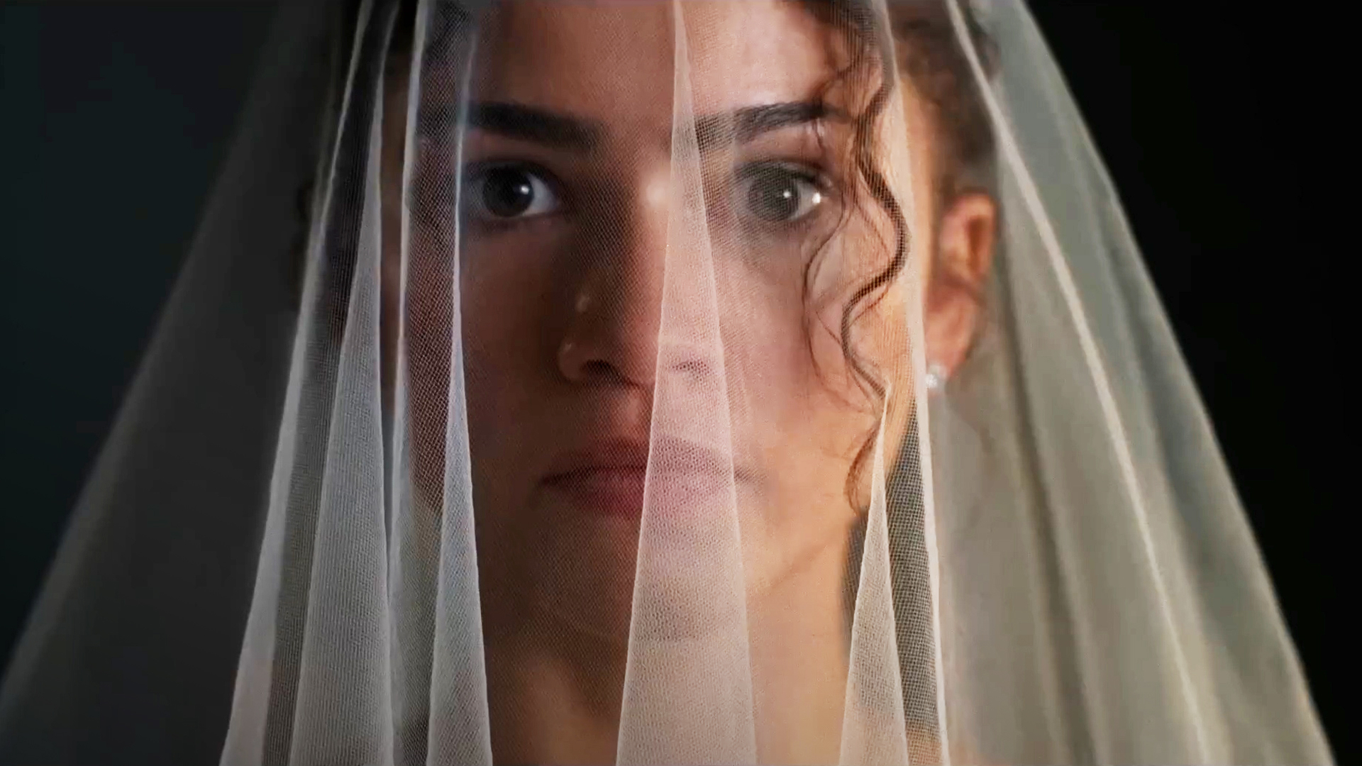 A close up of Zendaya wearing a veil in The Drama