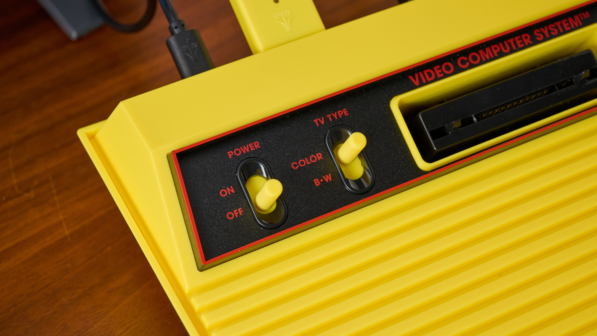 A closeup of the switches on the Atari 2600+ Pac-Man Edition, showing the Power switch and TV Type switch.