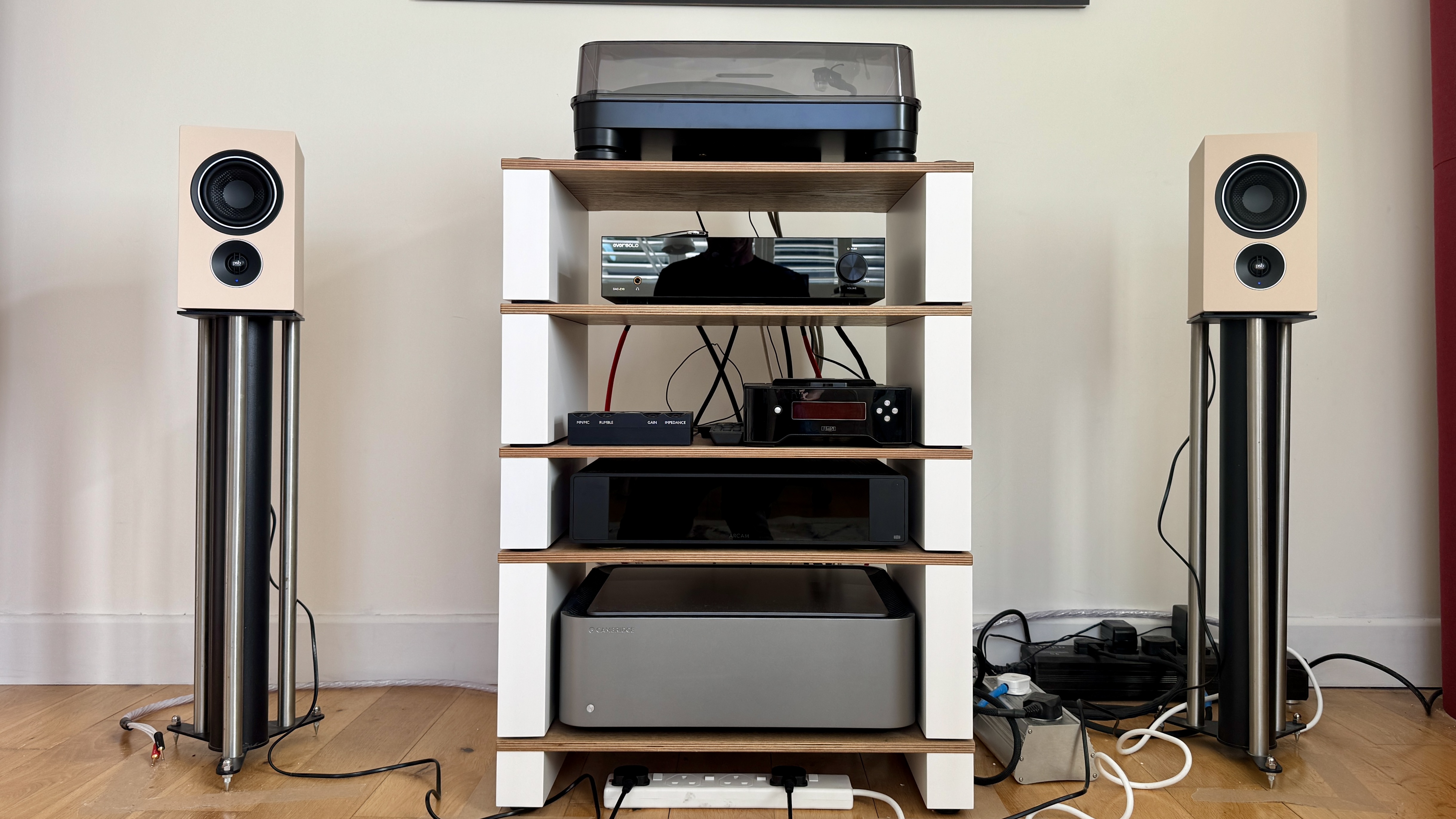 PSB iQ2 stereo speaker system on a wooden surface.