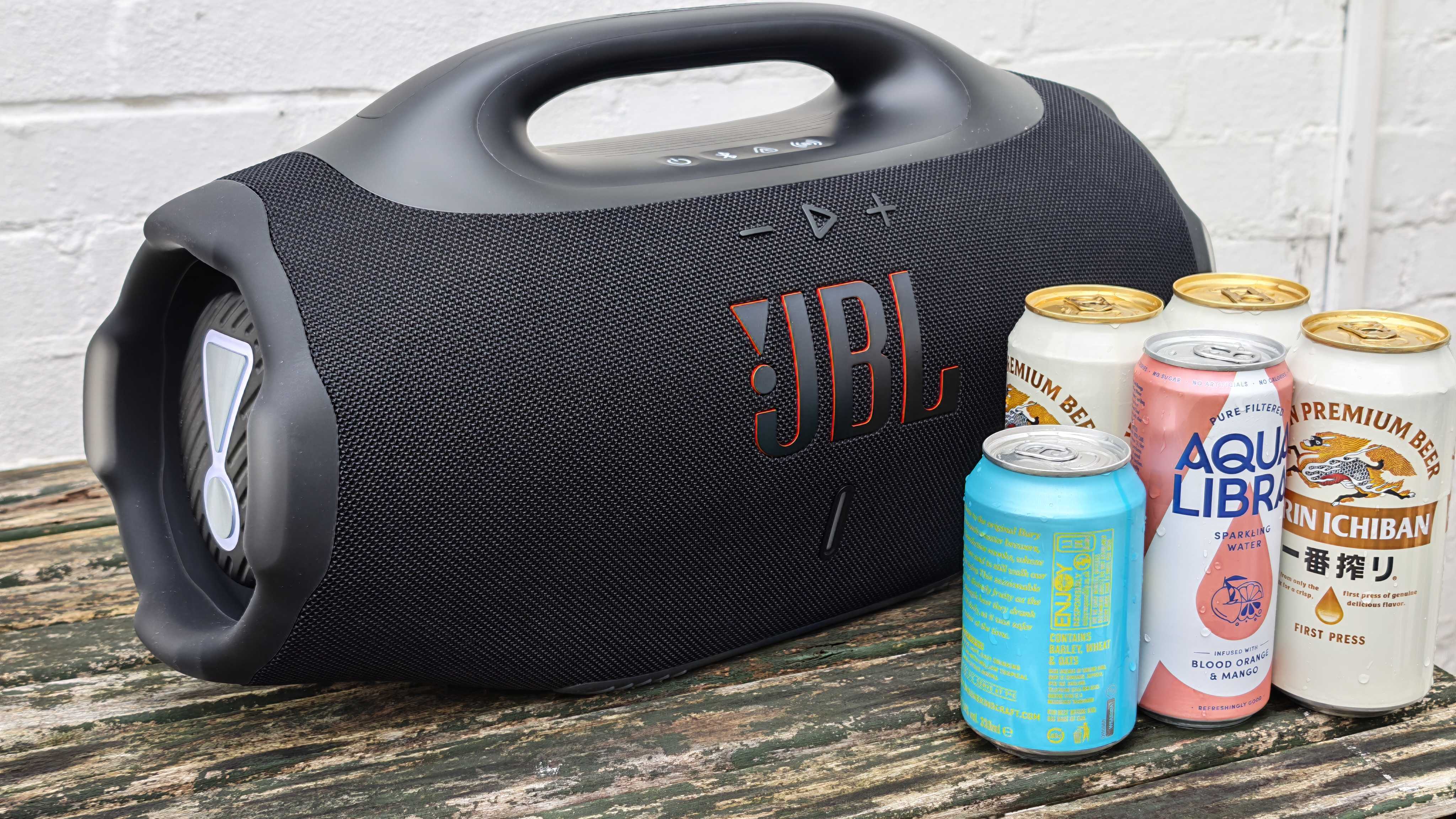The JBL Boombox 4 on a table outside.