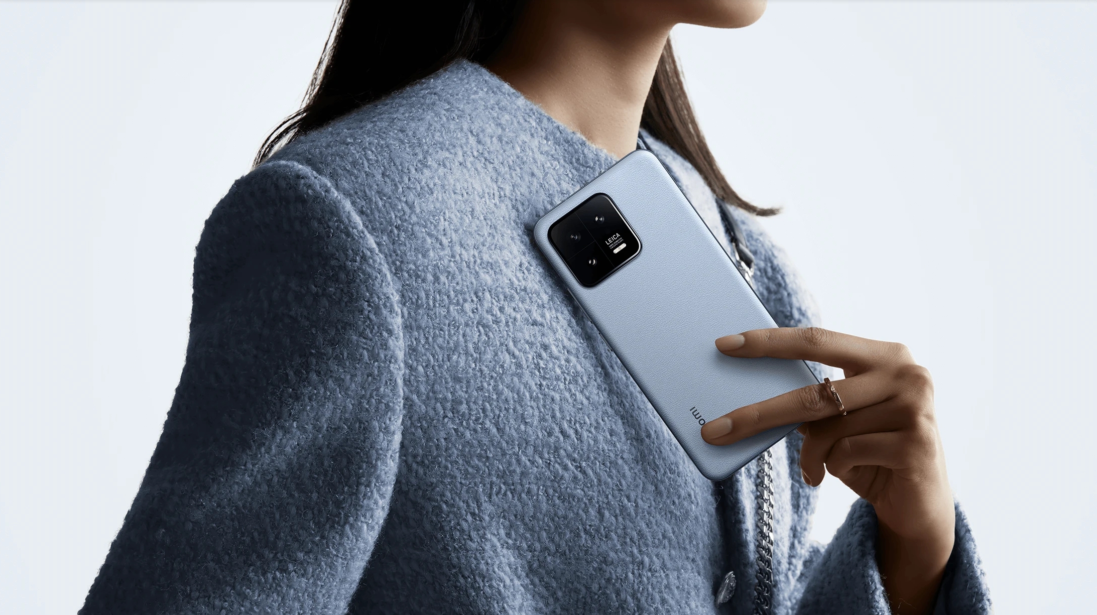 A Xiaomi 13 from the back in someone's hand
