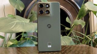 The Motorola Edge 70 perched on a brown table.