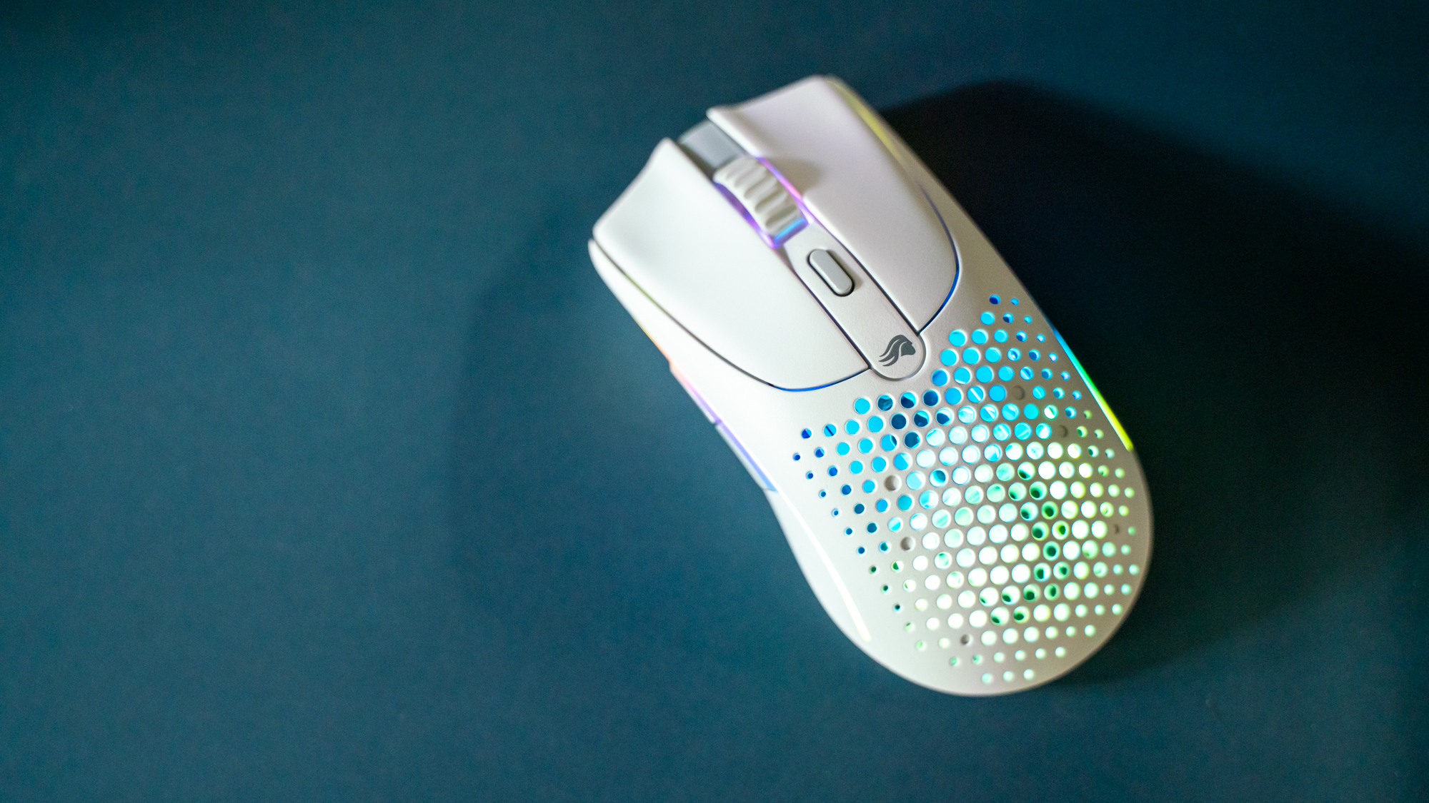 Glorious O2 Wireless on a dark blue desk pad