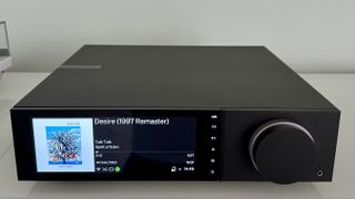 The Cambridge Evo 150 SE on a gray hi-fi rack, showing the color screen, grilles and ports