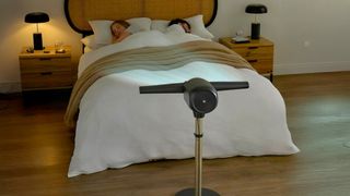Dimplex tower fan blowing air over bed at night while couple sleep