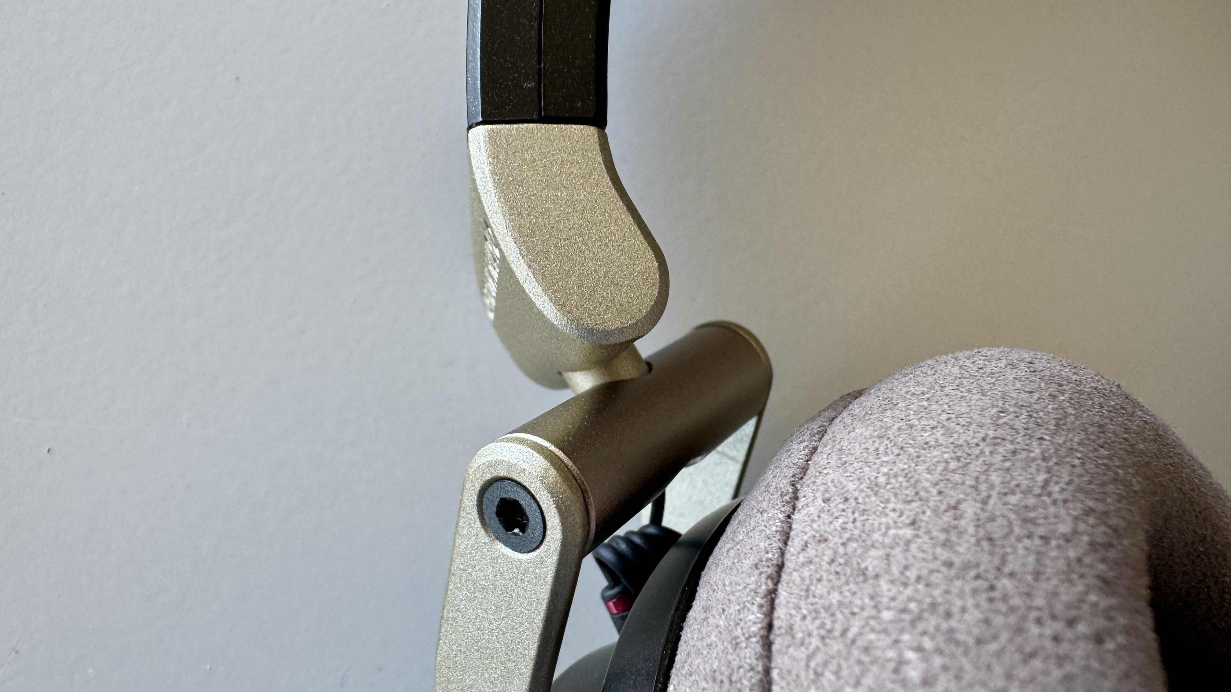 Close-up of the headband connector for the Austrian Audio The Arranger open-ear wired headphones, on a white background
