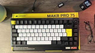 Corsair Makr Pro 75 gaming keyboard on a wooden desk