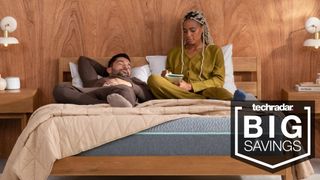 A couple on a Tuft & Needle Mint mattress, with a badge superimposed saying 'BIG SAVINGS'