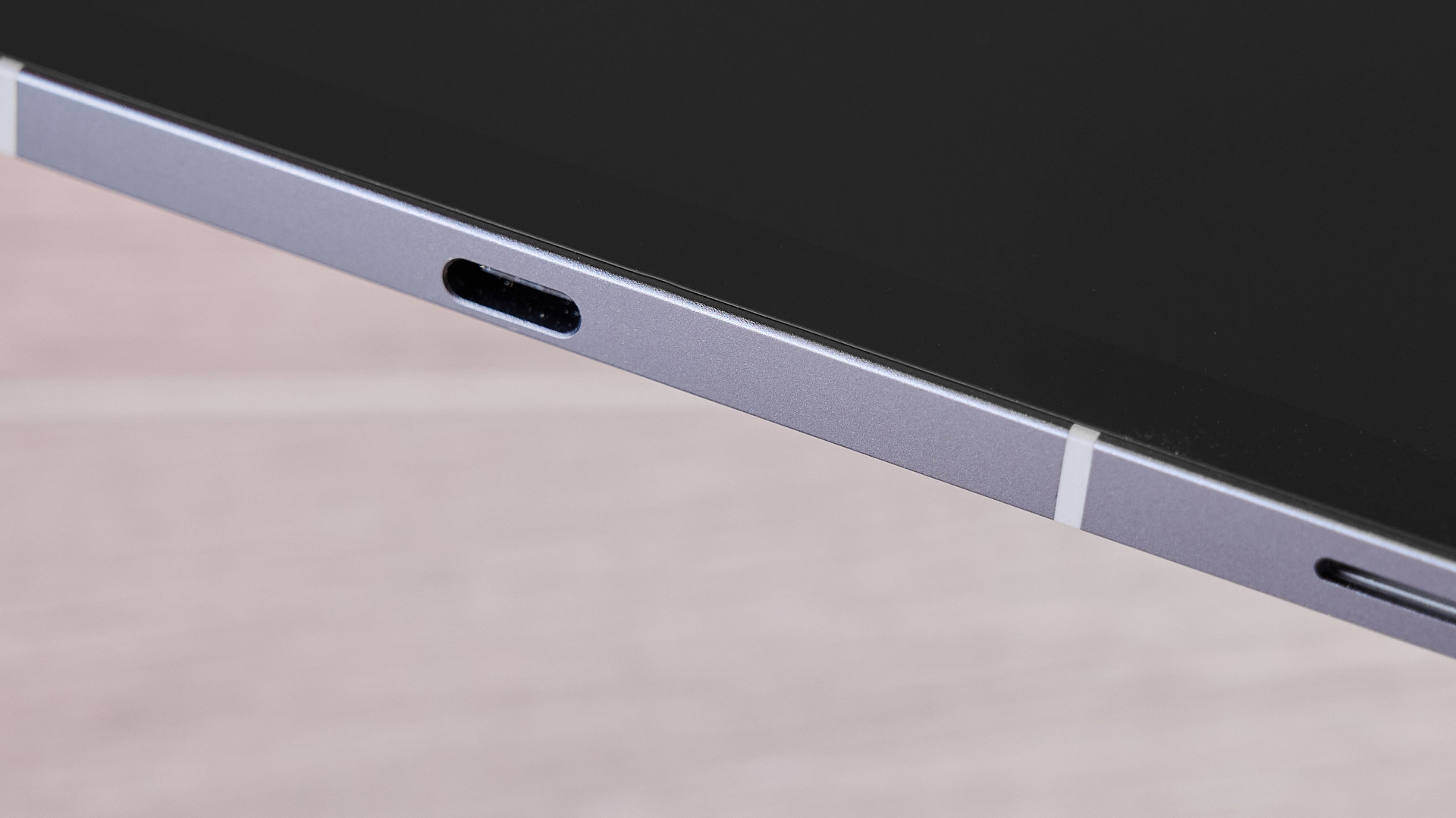 A closeup of the base of the Samsung Galaxy Tab S10 FE, showing its USB-C and microSD ports.