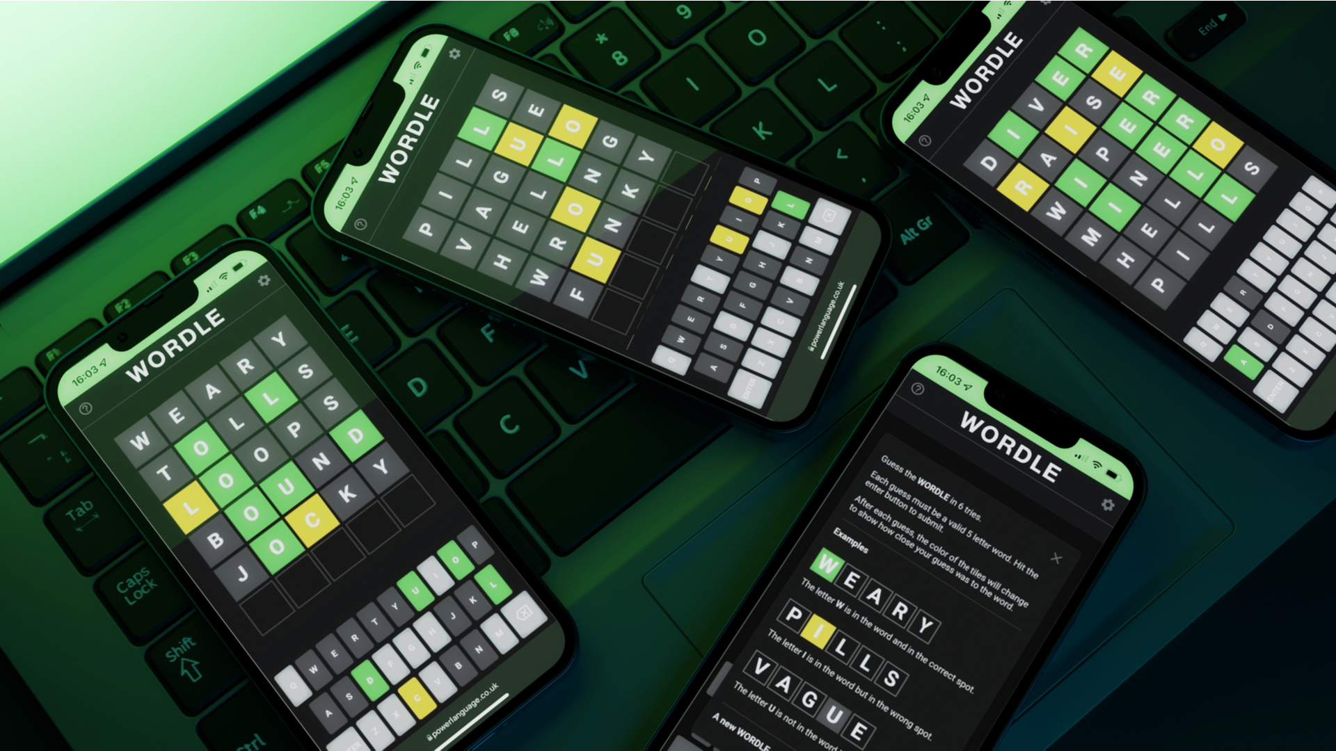 Wordle app: Several phones displaying wordle on a computer keyboard