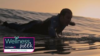 A surfer perched on the beginning of a wave in the Netflix documentary Resurface