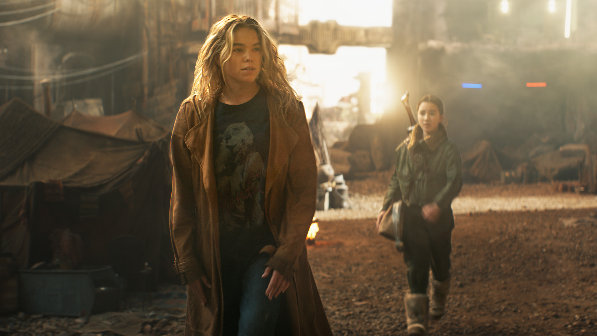 Kara Zor-El walking away from Ruthye on a dirty, industrial planet in Supergirl