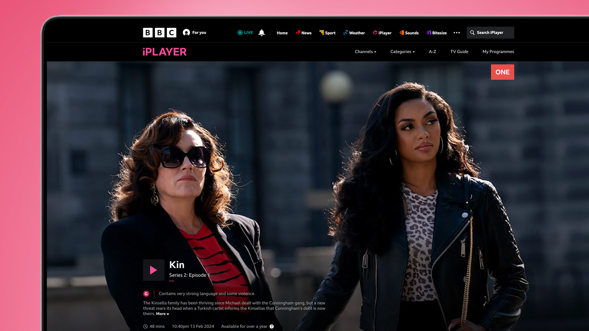 A laptop screen on a pink background showing BBC iPlayer