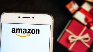 Amazon app on a phone and gift boxes