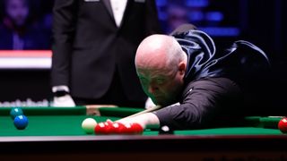 John Higgins plays a shot during the Tour Championship snooker.