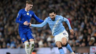 Cole Palmer and Rayan Cherki compete for the ball in a Premier League game.