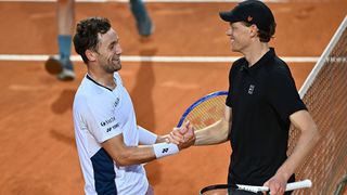 Casper Ruud and Jannik Sinner shake hands at the net after a match at the Italian Open 2025
