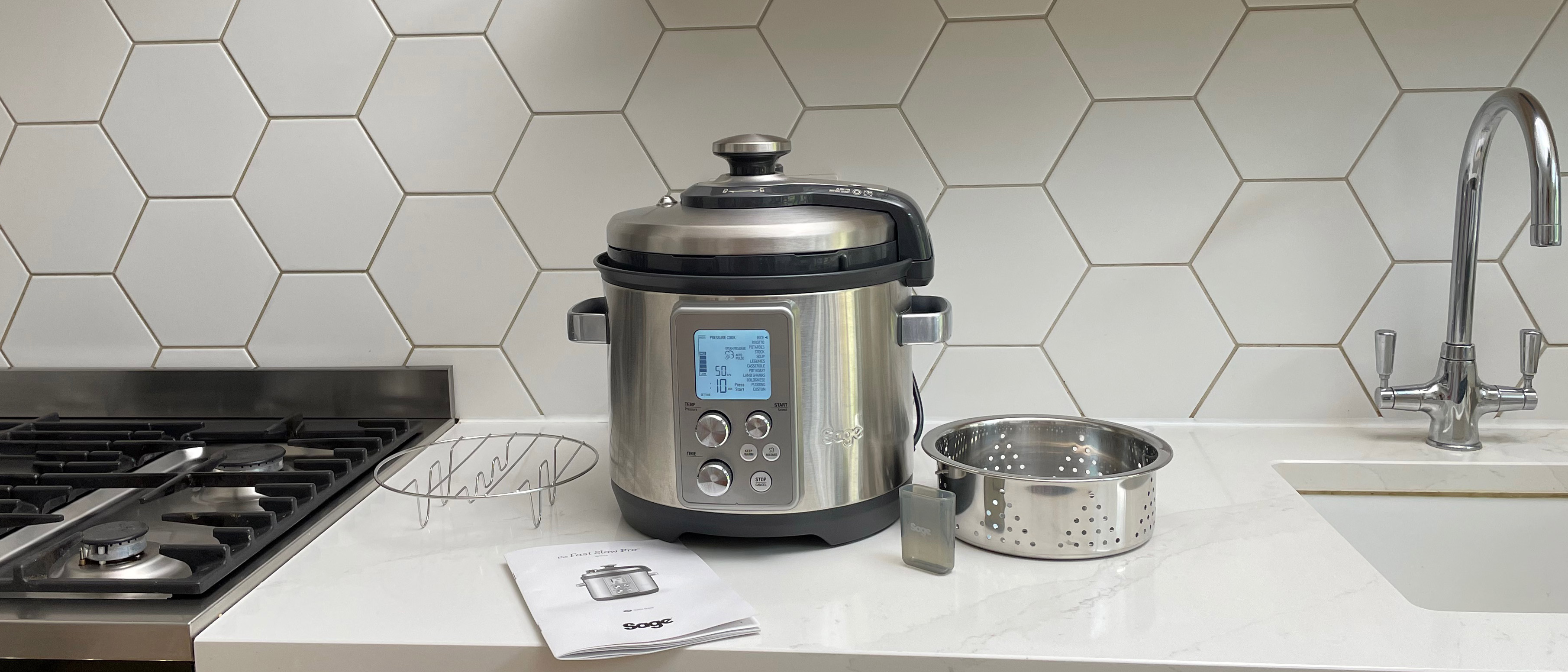 Breville the Fast Slow Pro on a kitchen countertop with its accessories laid out