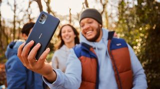 A Nokia G21 from the back in someone's hand