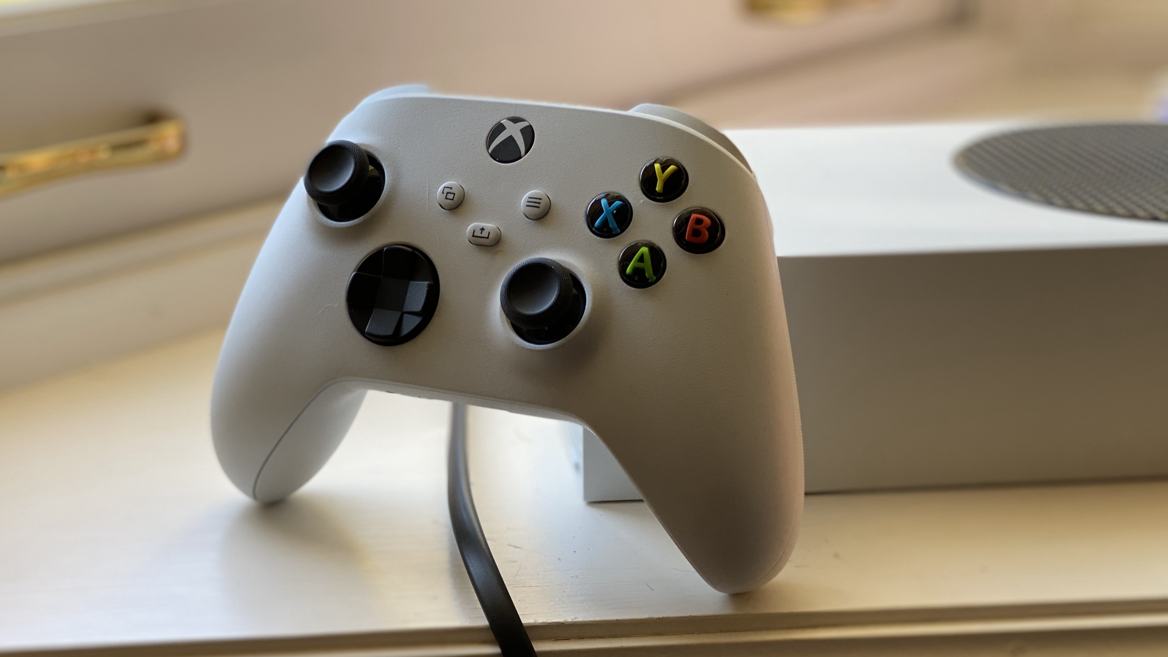 Xbox Series S controller leaning against the console
