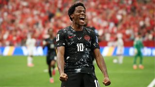 Jonathan David of Canada clenches his fists as he celebrates scoring a goal.