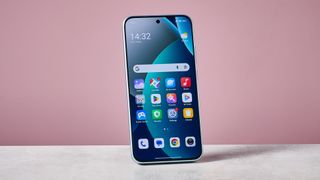 Xiaomi Redmi Note 15 Pro 5G against pink background with display on