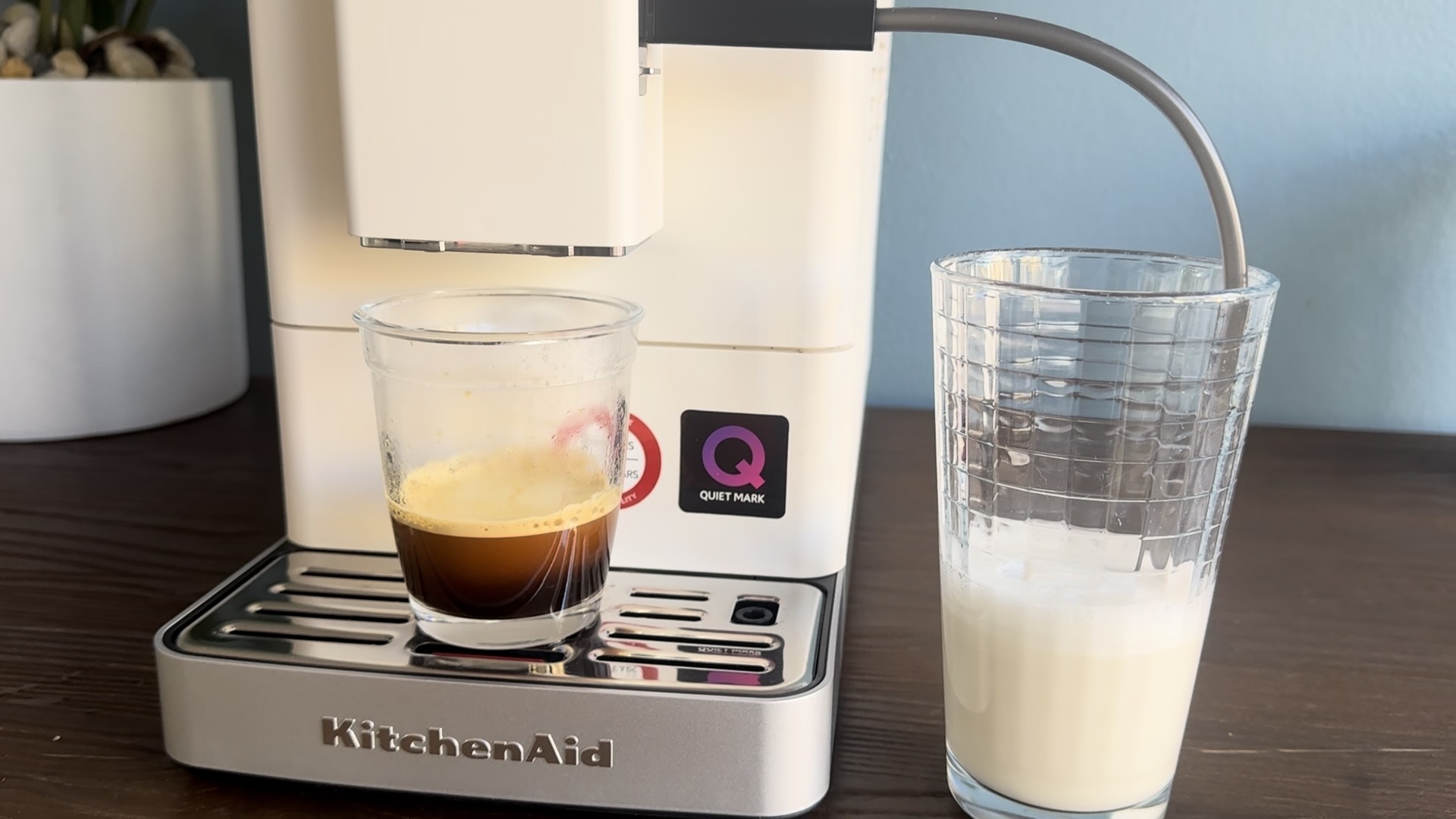 Coffee being poured and milk system being used with KitchenAid KF3.