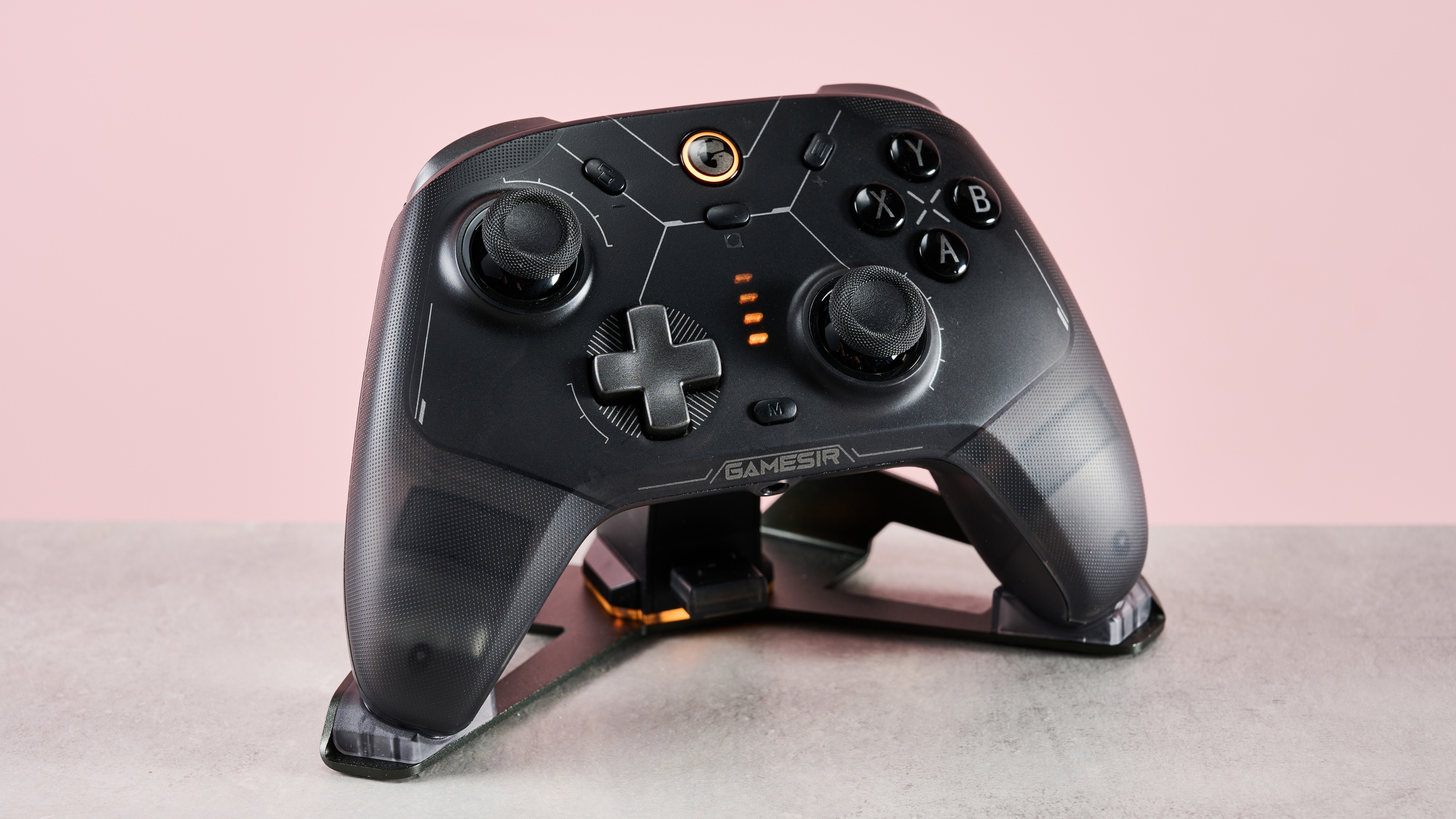 GameSir Cyclone 2 in charging stand on desk with pink background