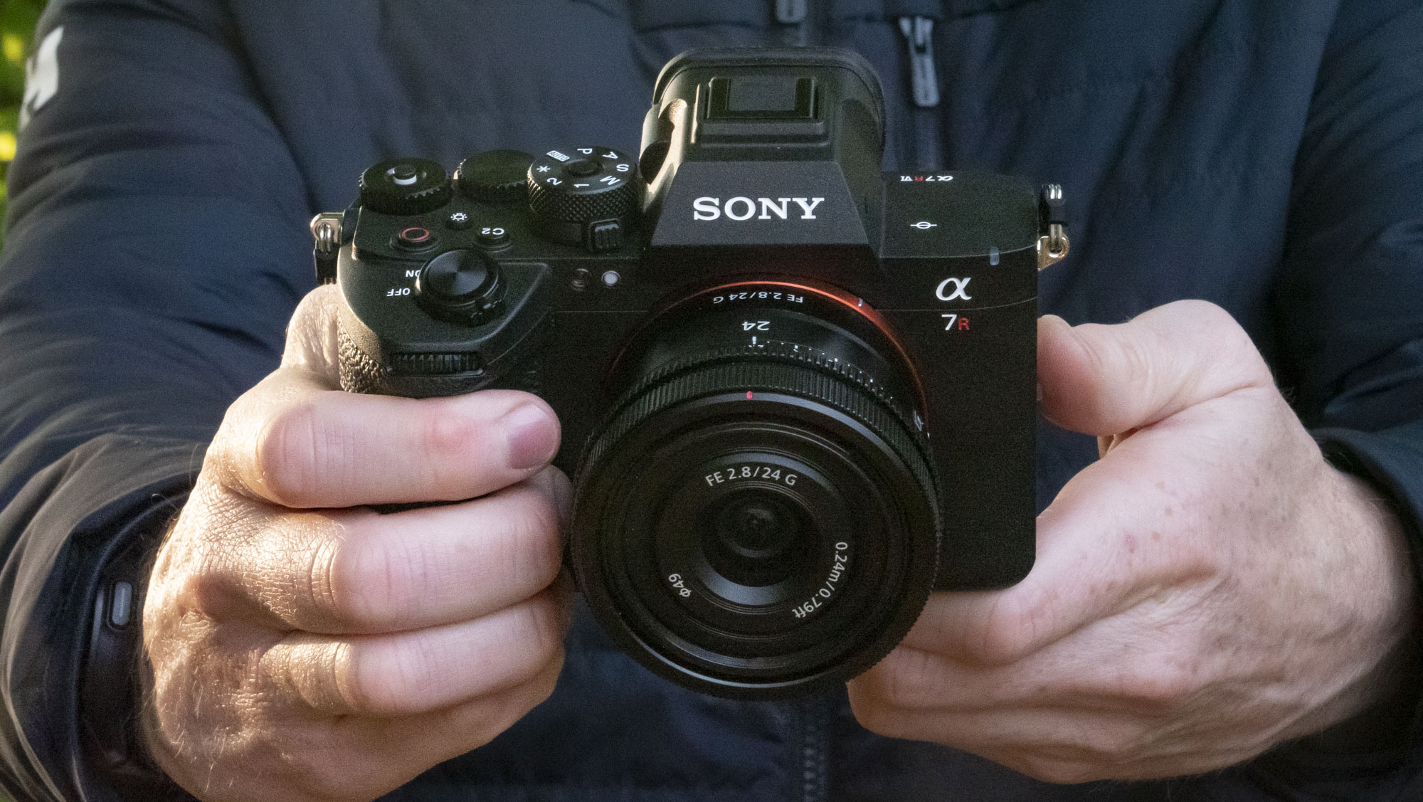 Sony A7R VI camera with 24mm F2.8 lens attached, in user's hands