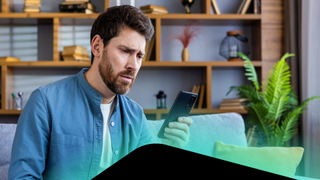 Man looking at phone after being scammed by an AI tool