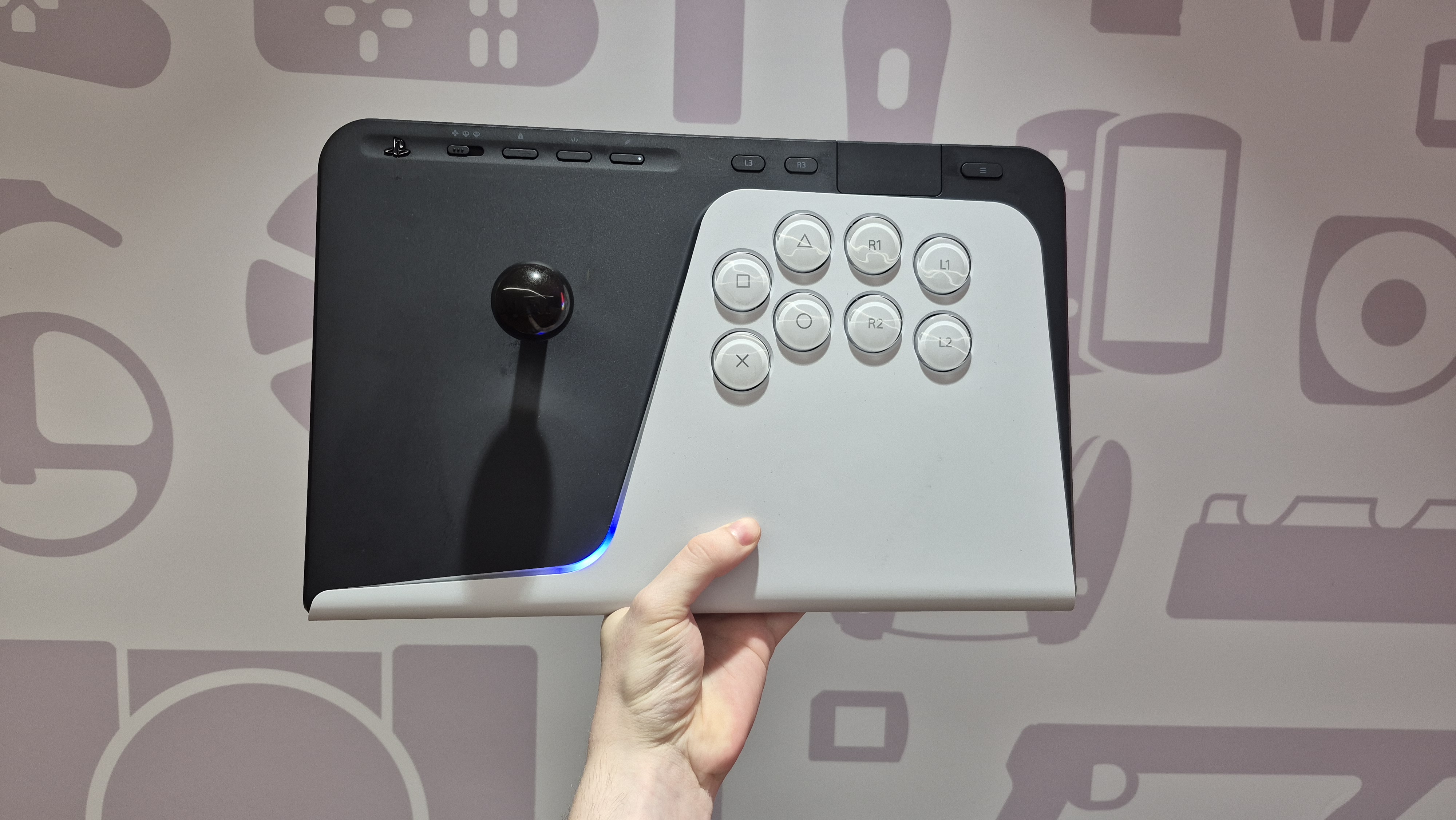 Man holding up FlexStrike Wireless Fight Stick against wall