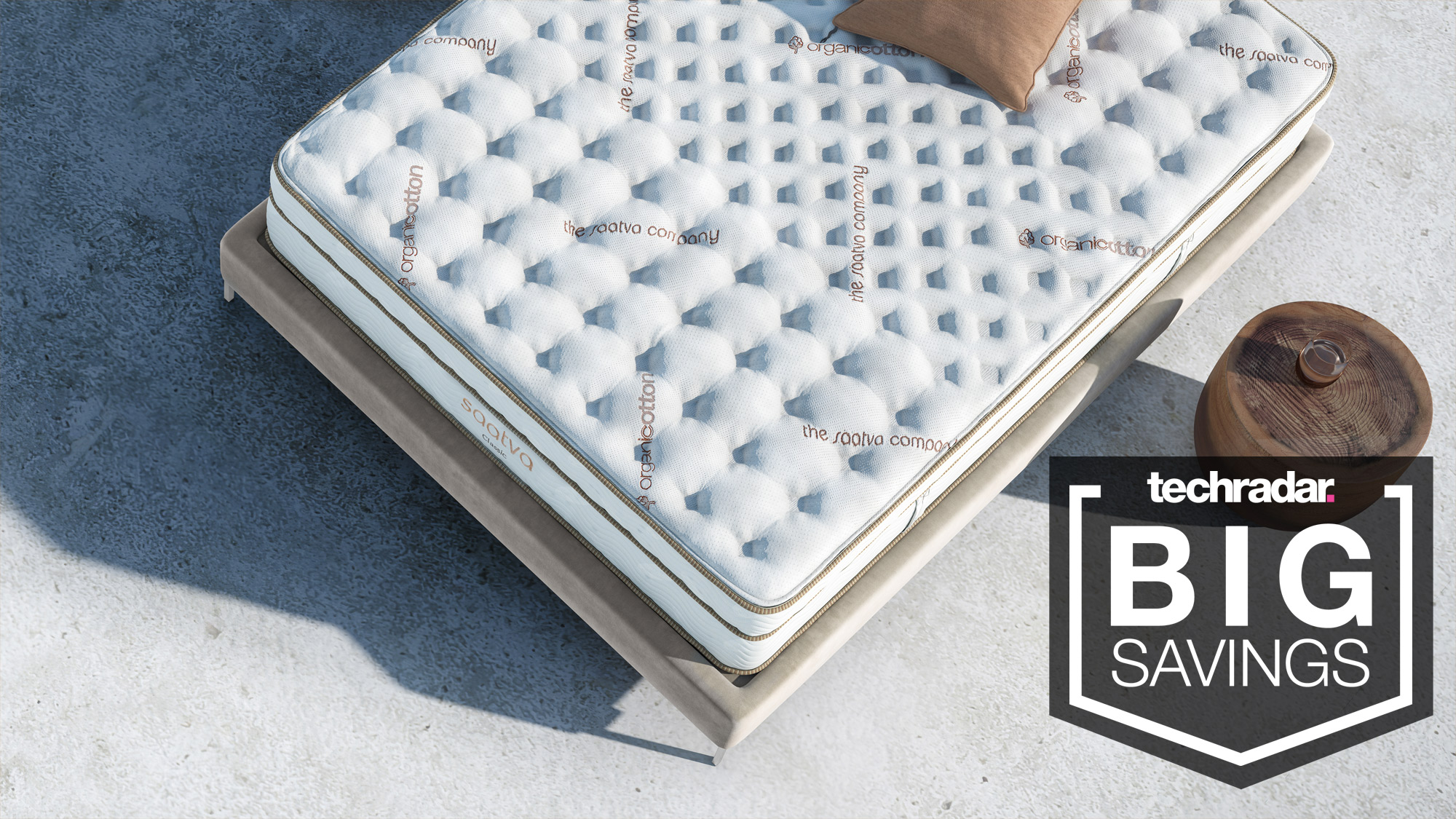 A Saatva Classic mattress seen from above, with a badge saying "BIG SAVINGS"