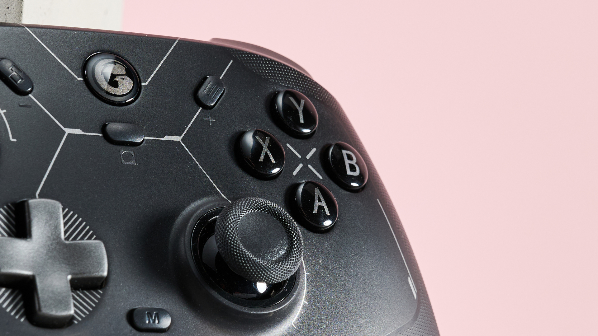 Close-up of right analog stick and face buttons on GameSir Cyclone 2 with pink background