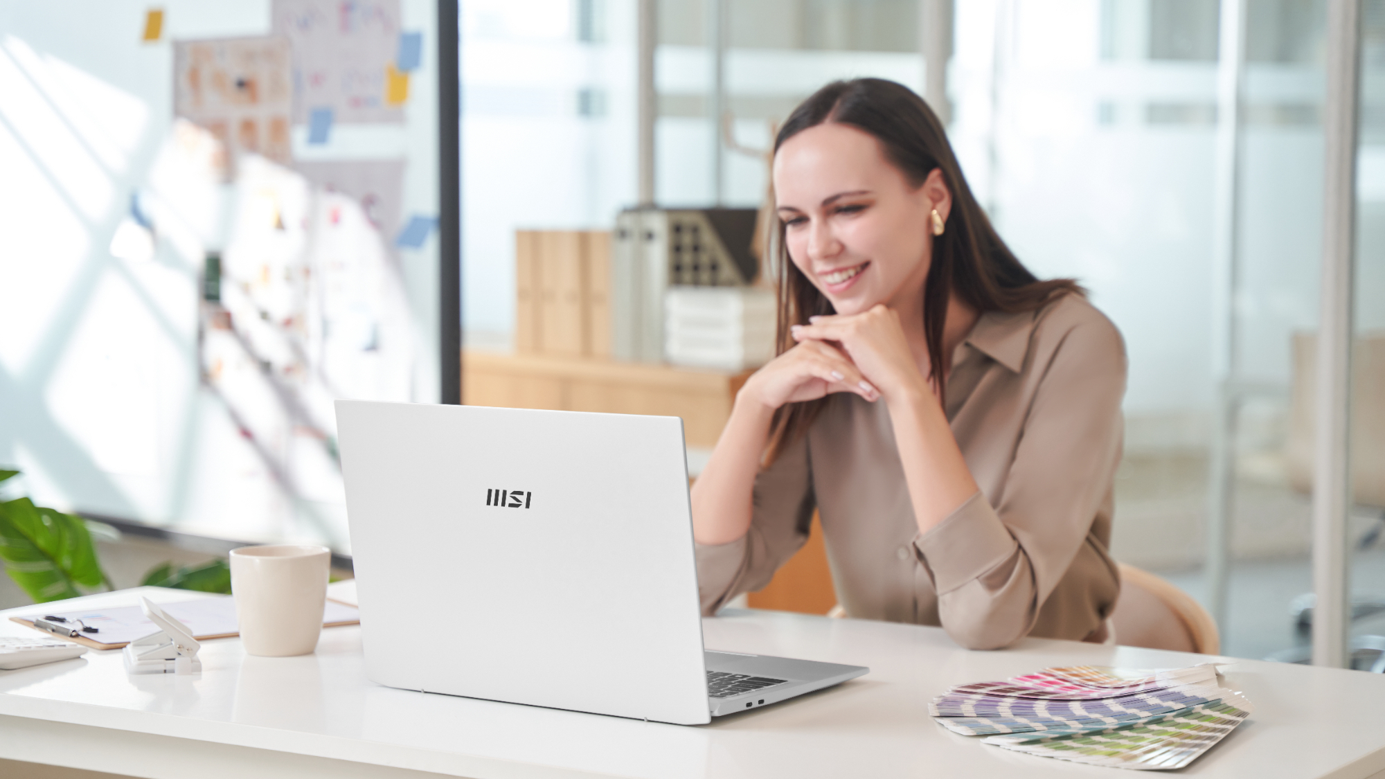 MSI promotional photo of a woman using a Prestige A16 AI+ laptop
