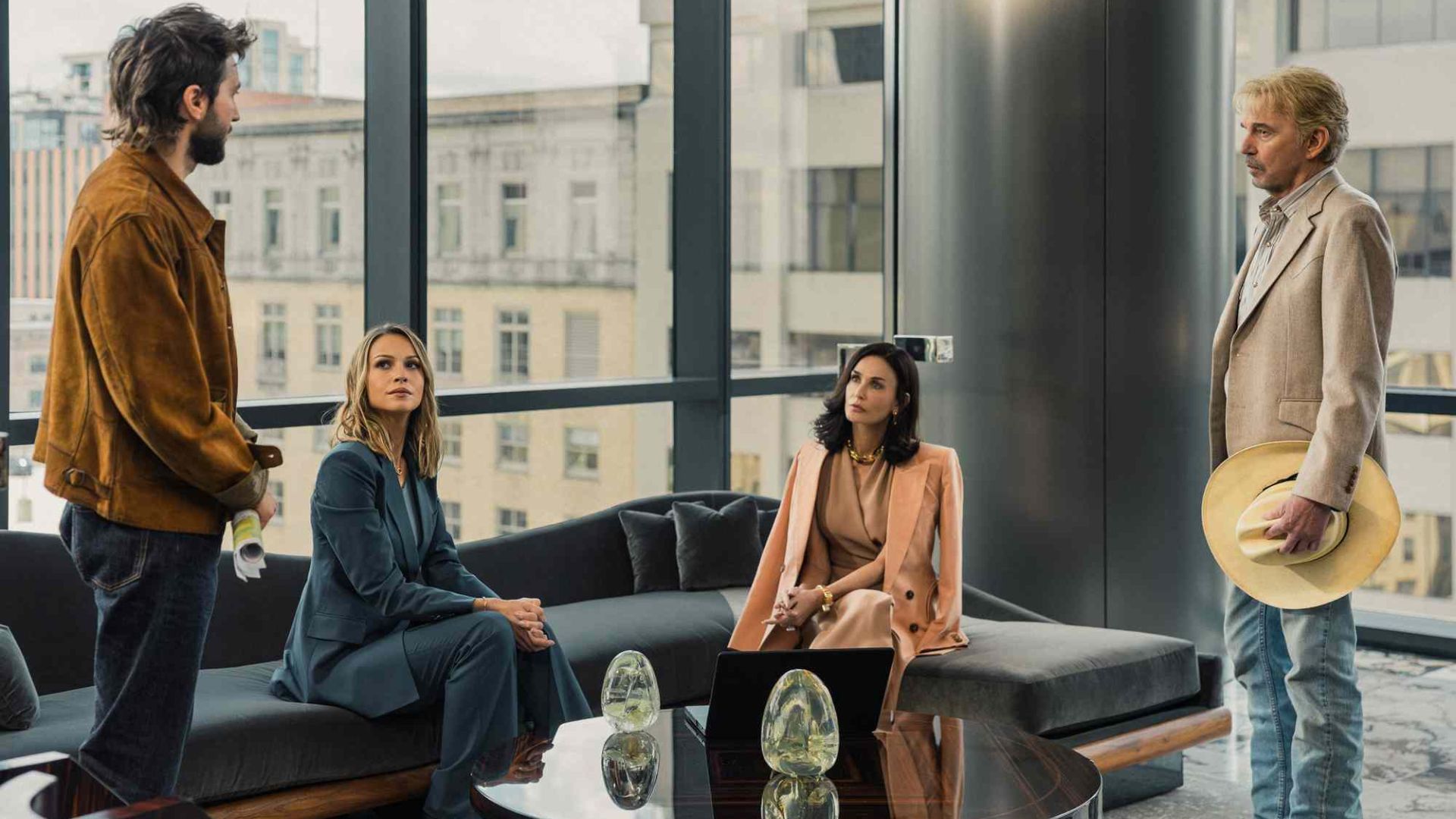 The cast of Landman in a board room