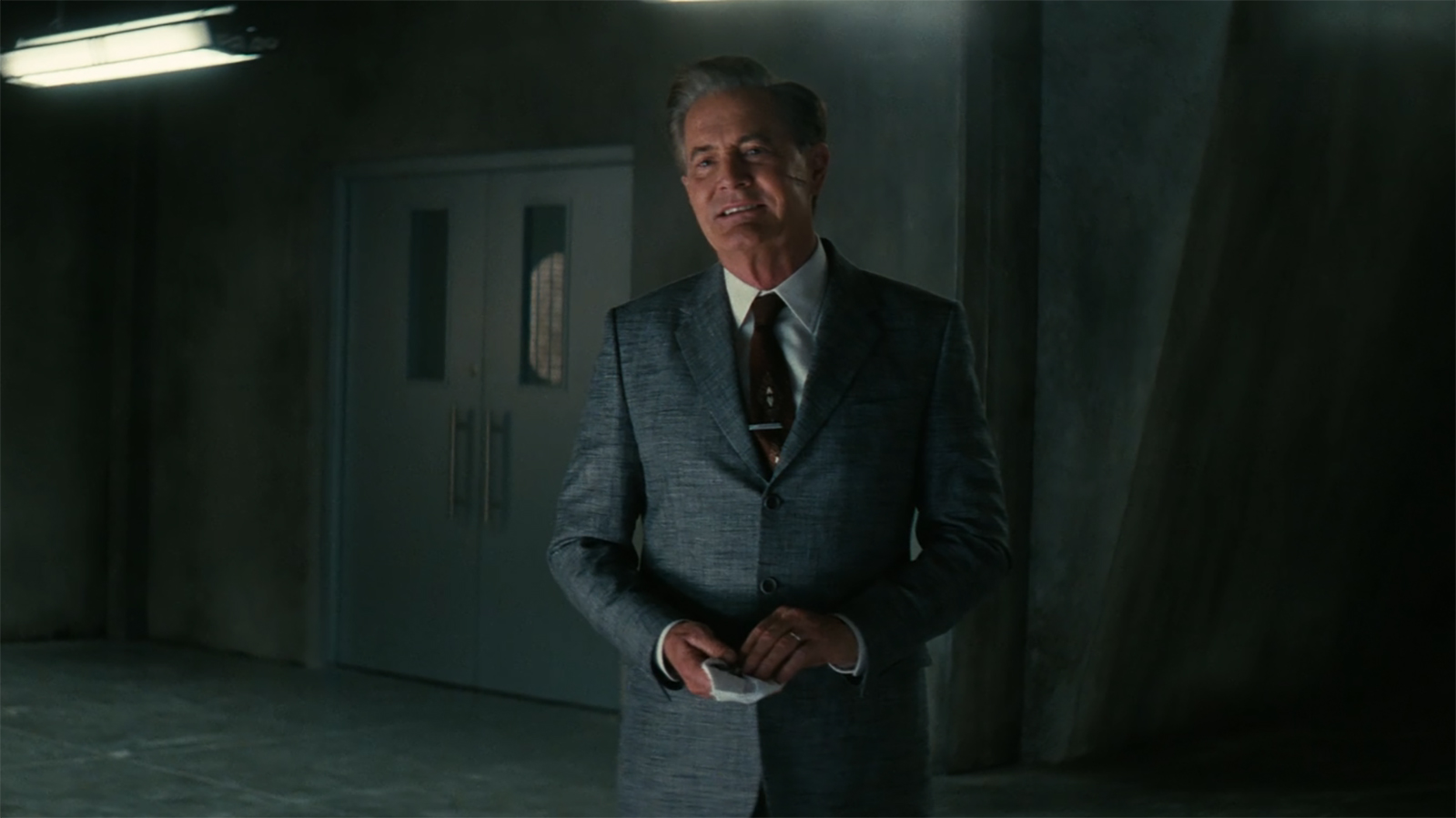 Hank holding a napkin and looking at an off-screen Lucy in Fallout season 2 episode 8