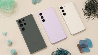 Samsung Galaxy S23 series lying face down on a cream table