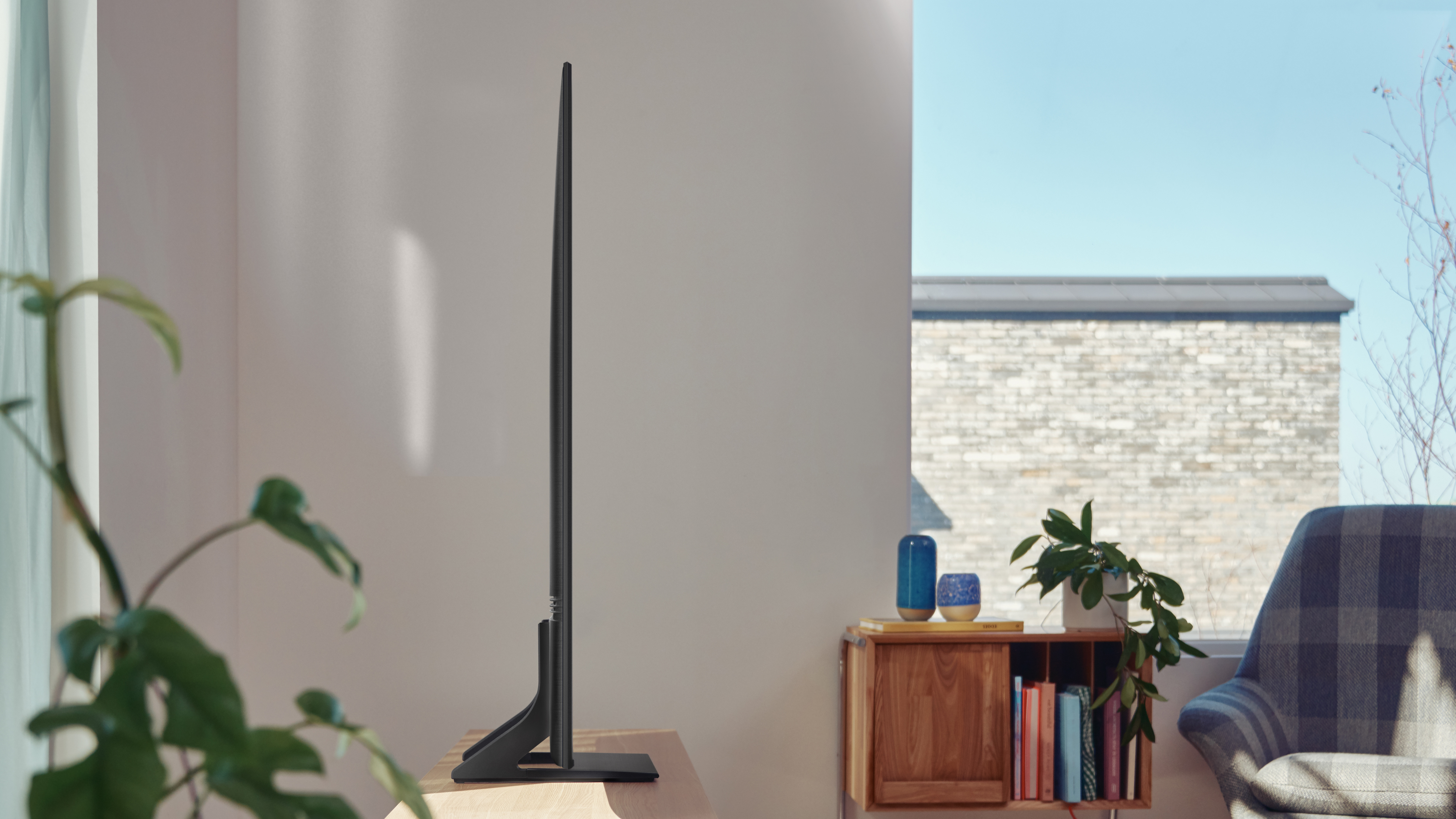 Side angle of the Samsung AU9000 TV in a living room.