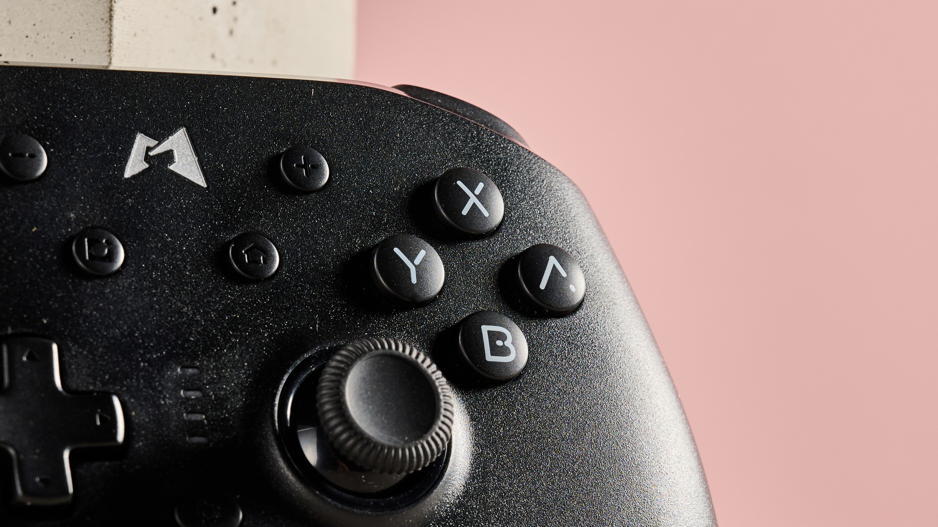 Close-up of analog stick and face buttons on Mobapad N1 HD with pink background