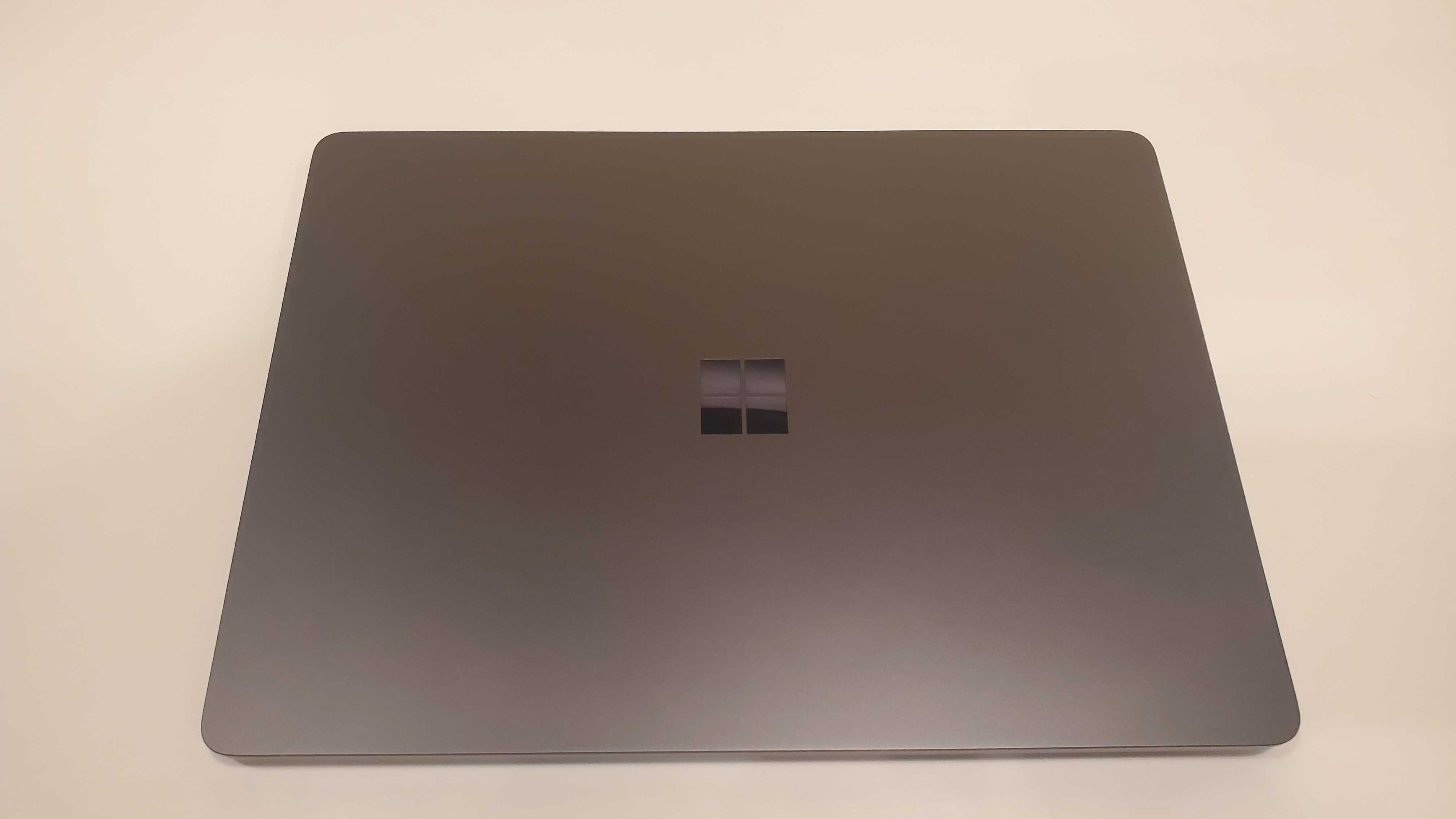black laptop on white table