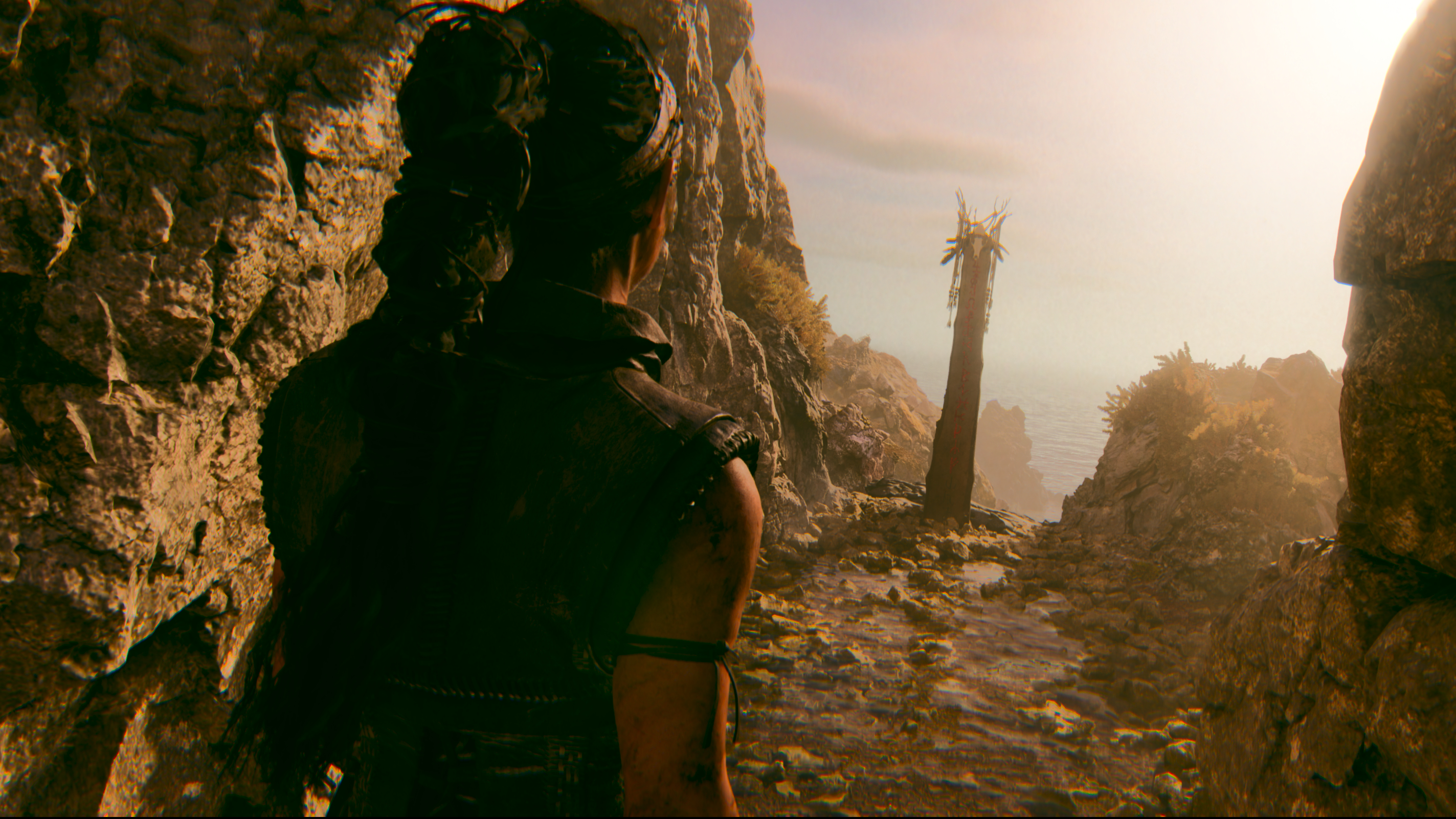 Senua looking at a lore stone in Senuas Saga Hellblade 2