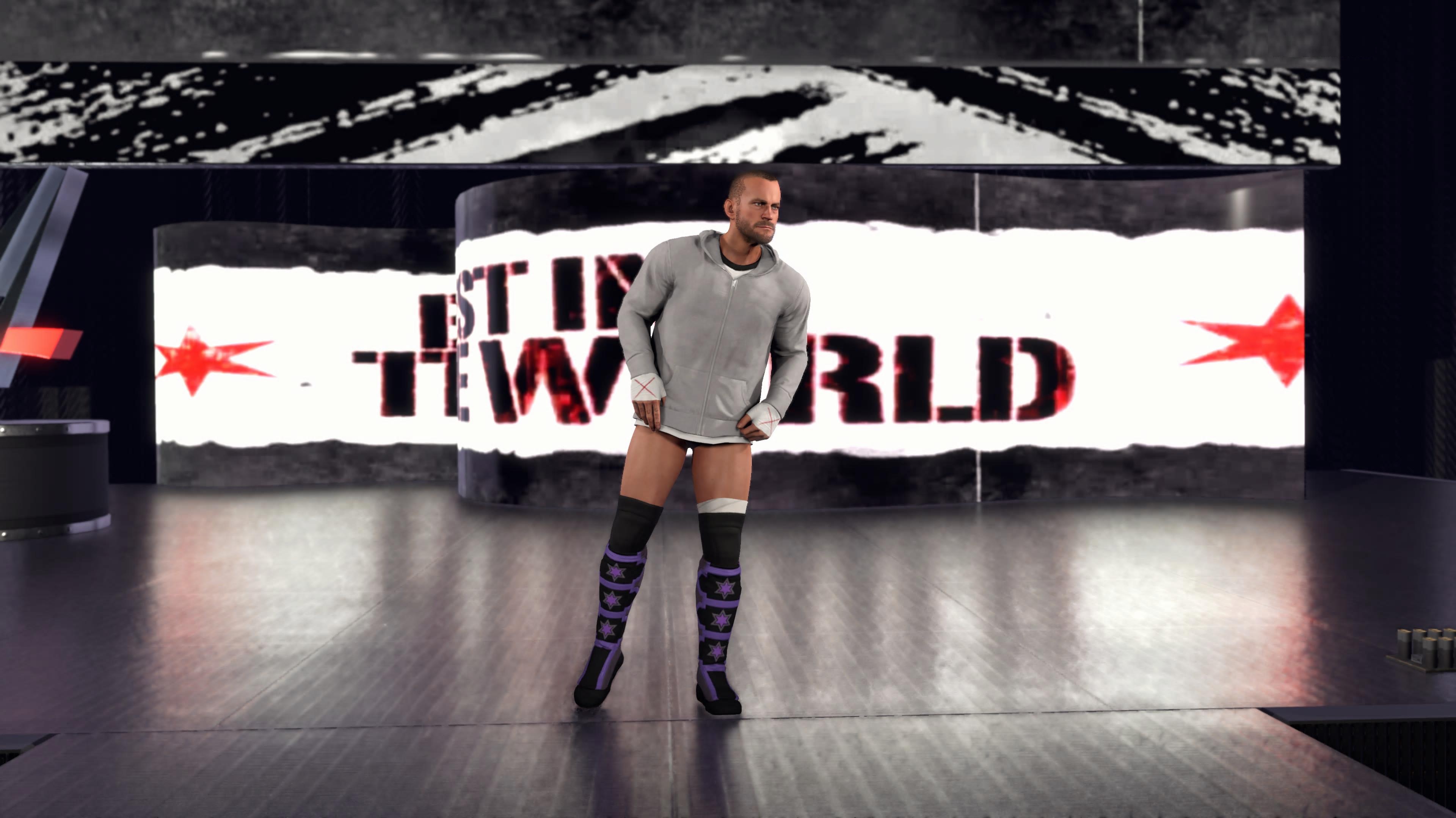 In-game screenshots from wrestling game WWE 2K26, showing wrestlers in the ring, making entrances, and the arena