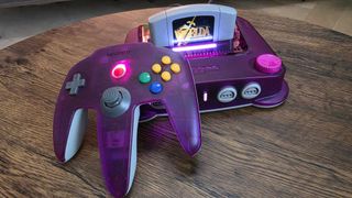 The ModRetro M64 and Pro controller next to each other on a wooden surface